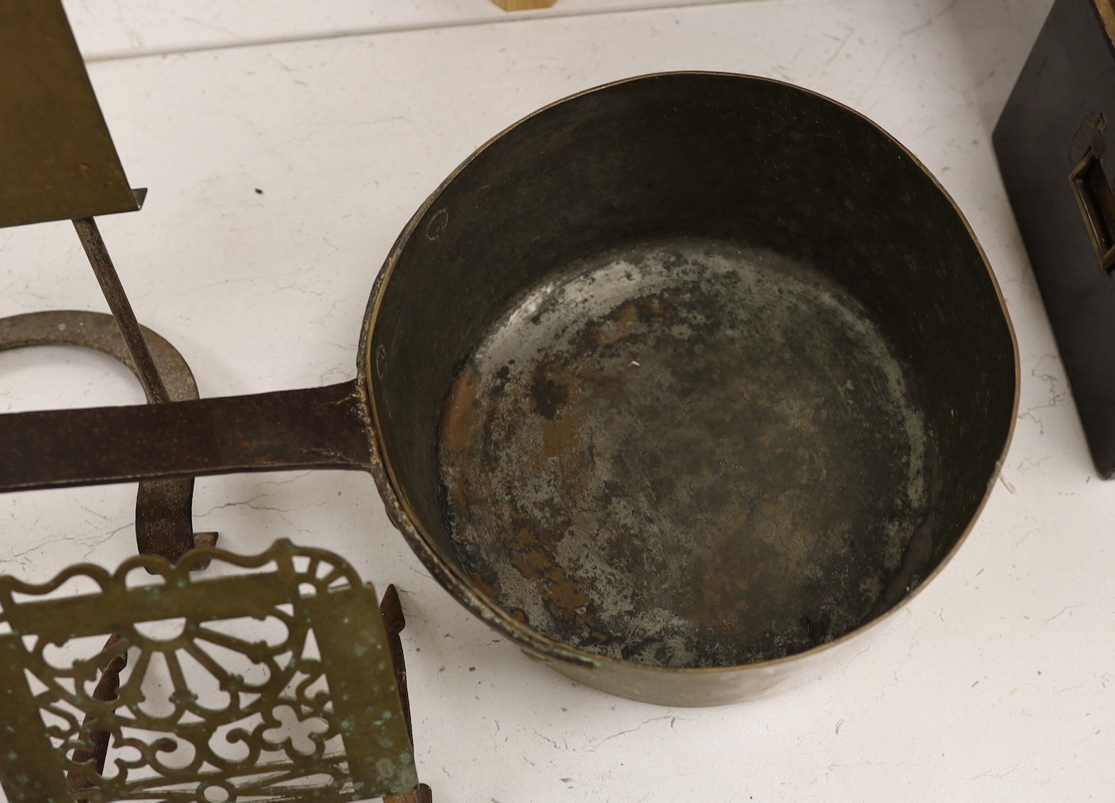 Two brass grate trivets, a crystal and brass towel rail and a 19th century copper pot